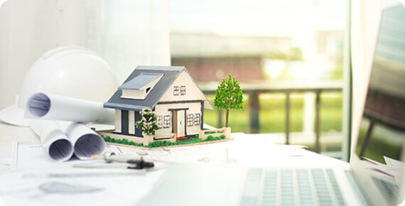 A model home beside architectural plans